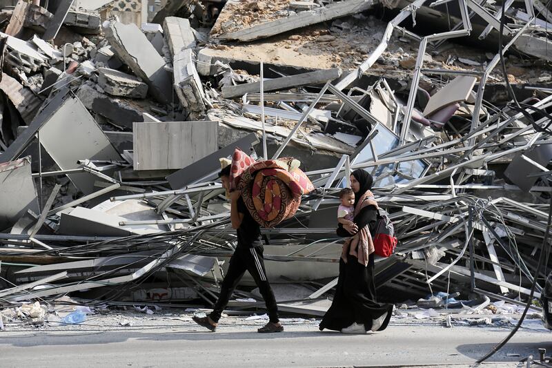 Residents carry a few belongings as they begin to evacuate following an Israeli warning of increased military operations in the Gaza Strip. EPA
