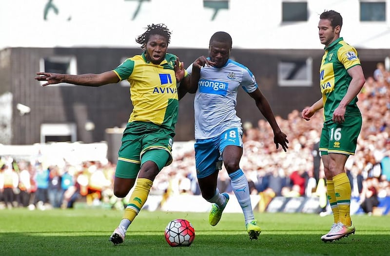 Norwich's Dieumerci Mbokani, left, and Newcastle's Chancel Mbemba vie for the ball as Matt Jarvis looks on. Norwich would later score the winning goal in injury time. Reuters / Alan Walter