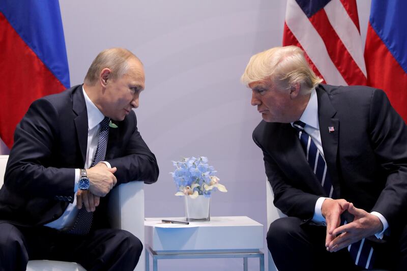 FILE PHOTO: Russia's President Vladimir Putin talks to U.S. President Donald Trump during their bilateral meeting at the G20 summit in Hamburg, Germany, July 7, 2017.  REUTERS/Carlos Barria//File Photo