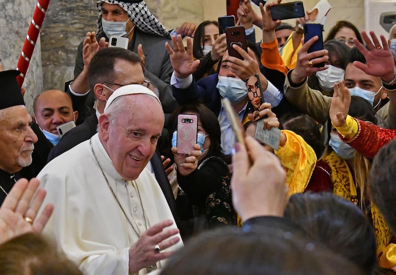 Pope Francis is greeted by people as he arrives at the Syriac Catholic Church of the Immaculate Conception (al-Tahira-l-Kubra), in the predominantly Christian town of Qaraqosh. AFP