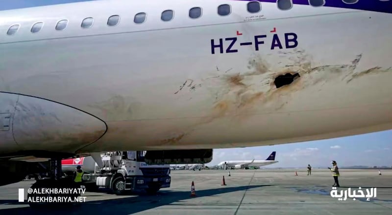 In this frame grab from video, Saudi state television shows an airplane damaged in an attack by Yemen's Houthi rebels at an airport near Abha, Saudi Arabia, Wednesday, Feb. 10, 2021. Yemen's Houthi rebels targeted the airport in southwestern Saudi Arabia, causing a civilian plane on the tarmac to catch fire, the kingdom's state television reported, an attack that threatens to escalate Yemen's grinding war. Authorities initially suspected the attack was carried out by a drone. (Saudi state television via AP)