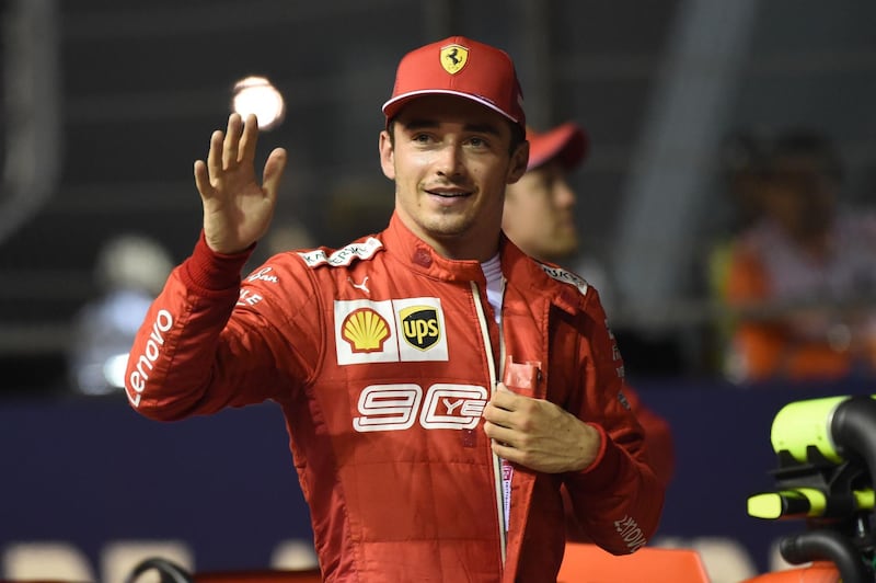 Ferrari's Monegasque driver Charles Leclerc celebrates after taking pole position after the qualifying session for the Formula One Singapore Grand Prix at the Marina Bay Street Circuit in Singapore on September 21, 2019. / AFP / ROSLAN RAHMAN
