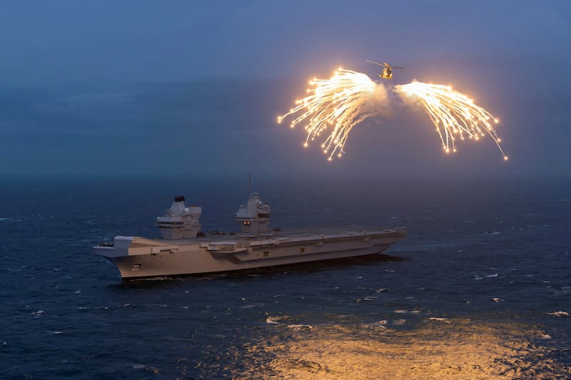 A British helicopter from the 820 Naval Air Squadron fires flares above the HMS Prince of Wales during Nato's Steadfast Defender military exercise. Reuters