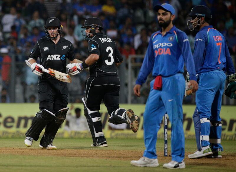 New Zealand's Tom Latham second from left, along with Ross Taylor runs between the wickets during their first one-day international cricket match against India in Mumbai, India, Sunday, Oct. 22, 2017. (AP Photo/Rafiq Maqbool)