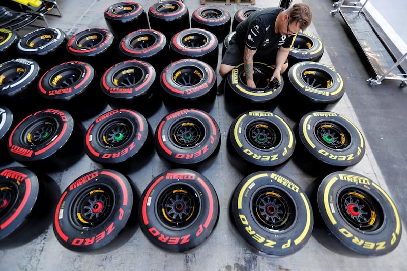 A team technician prepares tires ahead of the Formula One Abu Dhabi Grand Prix at Yas Marina Circuit, Abu Dhabi, on Wednesday, November 27. Reuters