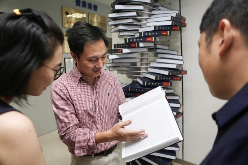 Scientist He Jiankui shows "The Human Genome", a book he edited, at his company Direct Genomics in Shenzhen, Guangdong province, China August 4, 2016. Picture taken August 4, 2016.  REUTERS/Stringer  ATTENTION EDITORS - THIS IMAGE WAS PROVIDED BY A THIRD PARTY. CHINA OUT.