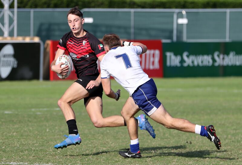 Players in action during the Gulf Under 19 boys cup semi-final 2 match between Dubai English Speaking College (black) vs Jumeirah English Speaking School (white and blue) held at The Sevens Stadium.