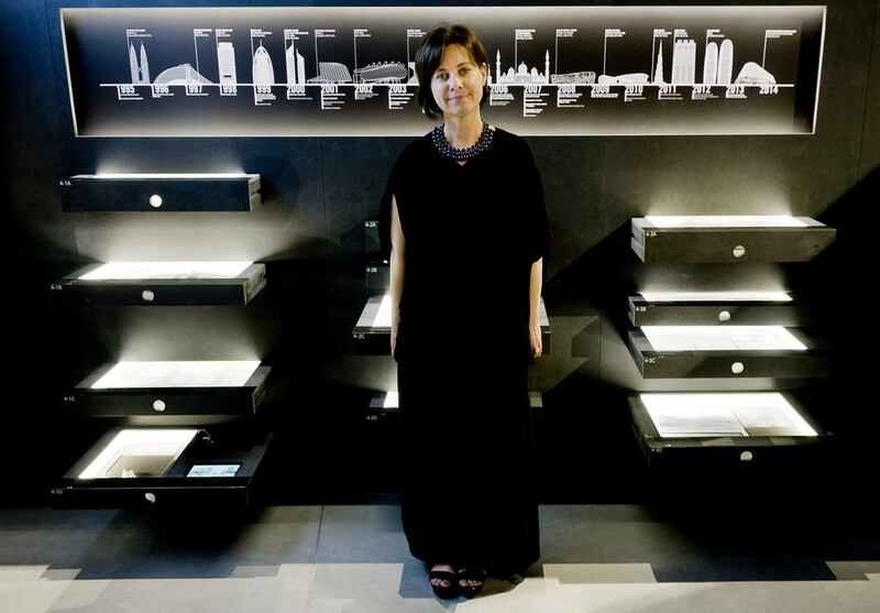 Michele Bambling, the curator os the UAE's National Pavilion, poses amid the drawers containing the exhibition 'Lest We Forget: Structures of Memory in the United Arab Emirates. Domenico Stinellis / AP Photo