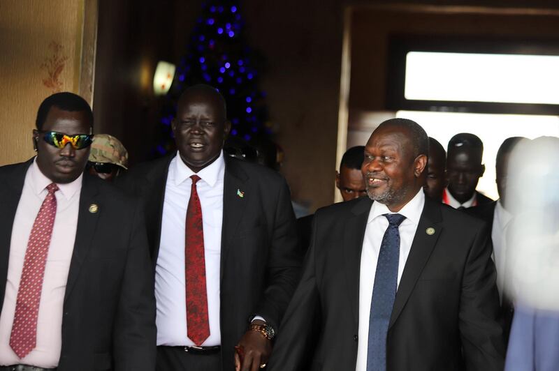 South Sudan's ex-vice president and former rebel leader Riek Machar, right, arrives at the Juba international airport for discussion with the government on the formation of a unity government, in Juba, South Sudan. REUTERS