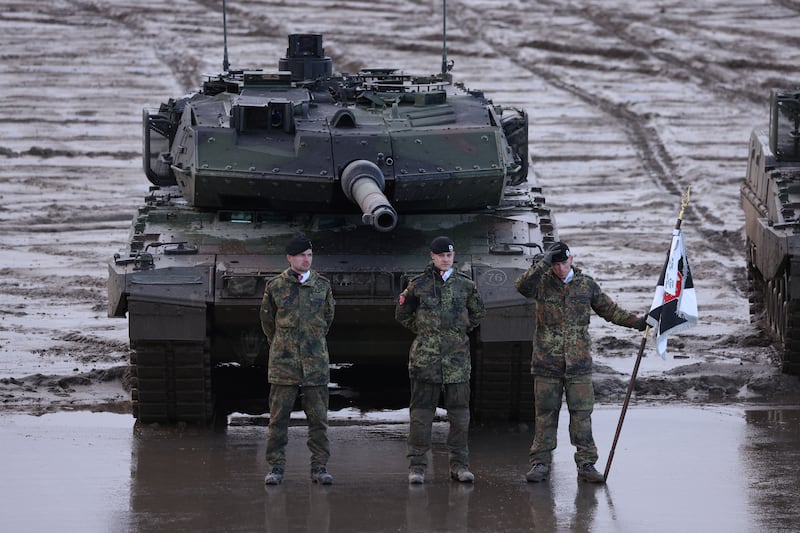 Members of Germany's armed forces stand in front of a Leopard 2 tank during a military exercise. Getty