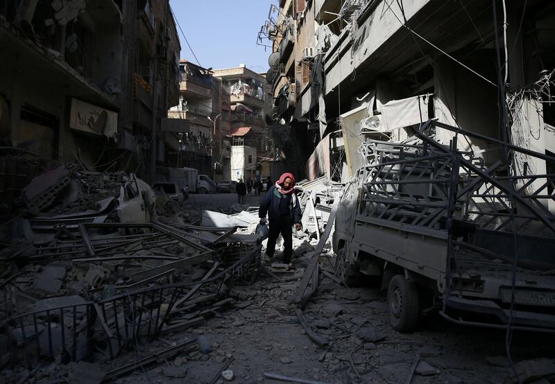 A man walks on the rubble of damaged buildings at the besieged town of Douma, Eastern Ghouta, Damascus, Syria on March 5, 2018. Bassam Khabieh / Reuters
