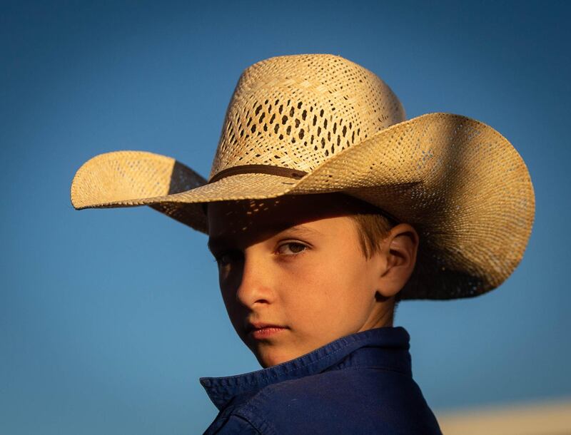 Larron Cook, winner of the 11 and under whip crack, looks on during the Harts Range Races and Rodeo. EPA