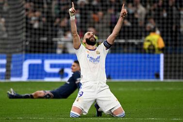 Real Madrid's French forward Karim Benzema celebrates after scoring a goal during the UEFA Champions League round of 16 second league football match between Real Madrid CF and Paris Saint-Germain at the Santiago Bernabeu stadium in Madrid on March 9, 2022.  (Photo by GABRIEL BOUYS  /  AFP)