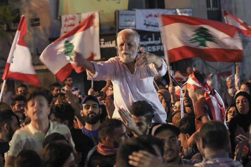 Lebanese protesters chant slogans and wave their country's national flag during ongoing anti-government demonstrations in Lebanon's southern city of Sidon (Saida). AFP