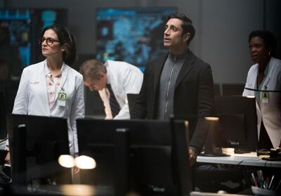 This image released by Sony Pictures shows Jenny Slate, left, and Riz Ahmed in a scene from "Venom." (Jessica Miglio/Sony Pictures via AP)