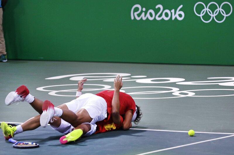Rafael Nadal, of Spain, top, embraces partner Marc Lopez as they celebrate after defeating Canada in their men’s doubles match at the 2016 Summer Olympics in Rio de Janeiro, Brazil, Thursday, August 11, 2016. Charles Krupa / AP Photo