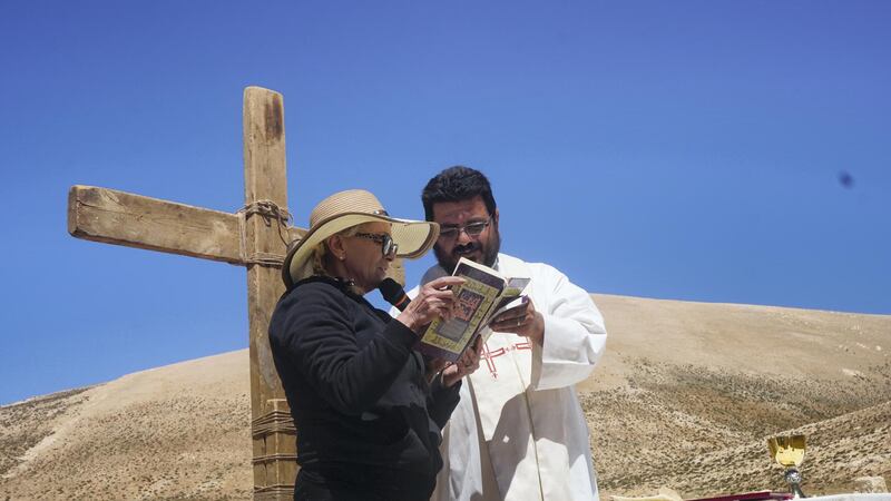 Marie Tawk reads the Bible during mass celebrated by priest Hani Tawk on Qornet Al Sawda, Lebanon, August 9, 2020. Photo by Aram Abdo