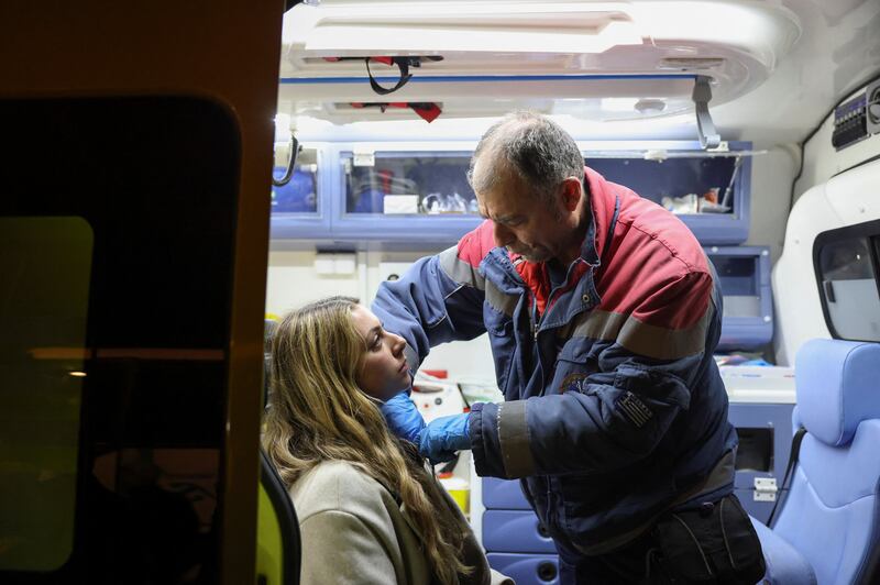 A medic treats a passenger who survived the crash, in Thessaloniki. Reuters