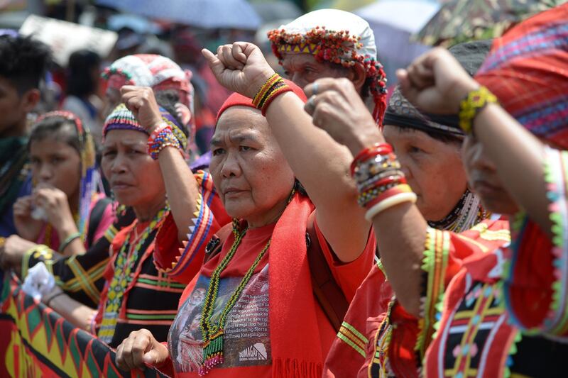 Activists from an indigenous group raise clenched fists during a protest near Malacanang palace to commemorate International Women's Day in Manila.  AFP