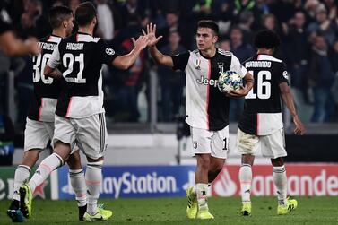 Juventus' Paulo Dybala, right, celebrates with Gonzalo Higuain after scoring during the Champions League match Juventus against Lokomotiv Moscow. AFP