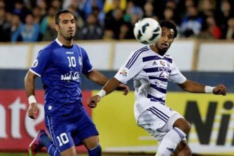 Mohamed Ahmad of Al Ain, right, tries to control the ball against Siavash Akbarpour of Esteghlal during their soccer match in AFC Champions League at the Azadi stadium in Tehran.