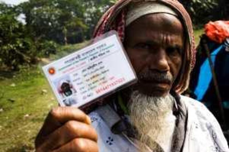 Md. Eyemuddin Shikdar poses with his new voters' identity card in Khariya village of Munshijung district, 45 kms outside of Dhaka, Bangladesh. Bangladesh's river gypsies (commonly known as Bedes) exercised their voting rights for the first time.
Photo: Sanjit Das for The National *** Local Caption ***  sdas20081231_rivergypsies_bangladesh0205.jpg