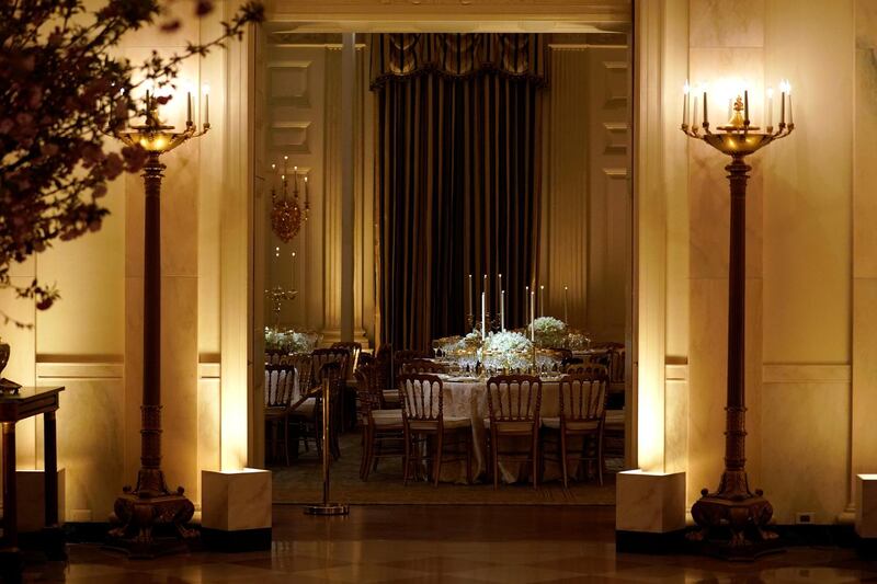 Tables for the State Dinner for French President Emmanuel Macron are shown from the Cross Hall of the White House in Washington, US, on April 23, 2018. Joshua Roberts / Reuters