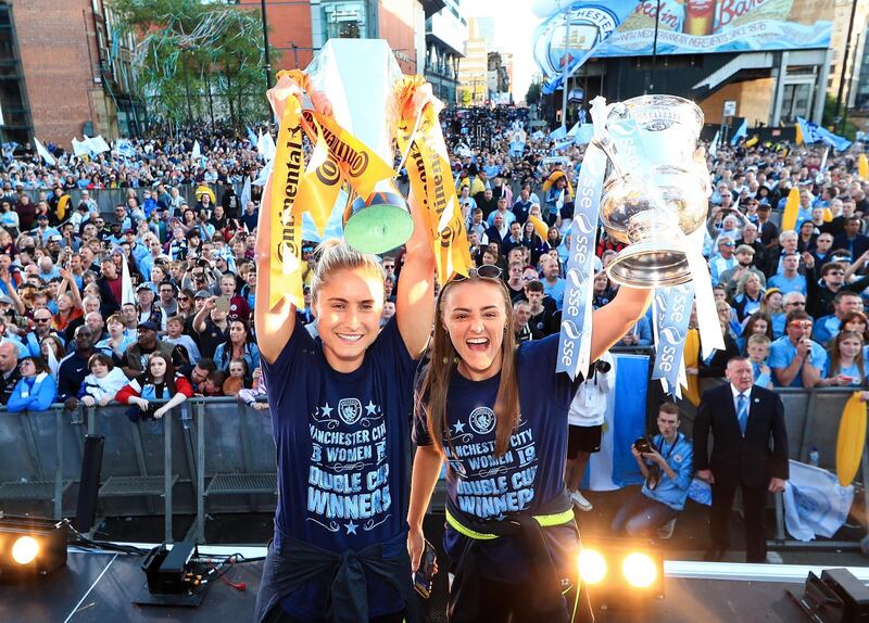 MANCHESTER, ENGLAND - MAY 20: Steph Houghton and Georgia Stanway of Manchester City celebrate with the Women's FA Cup and Continental Cup trophies during the Manchester City Teams Celebration Parade on  on May 20, 2019 in Manchester, England. (Photo by Matt McNulty - Manchester City/Manchester City FC via Getty Images)