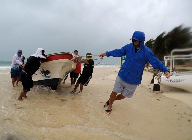 Fishermen move a boat to safety during strong wings and waves due the influence of  tropical storm Cristobal in Puerro Morelos, Mexico.  EPA