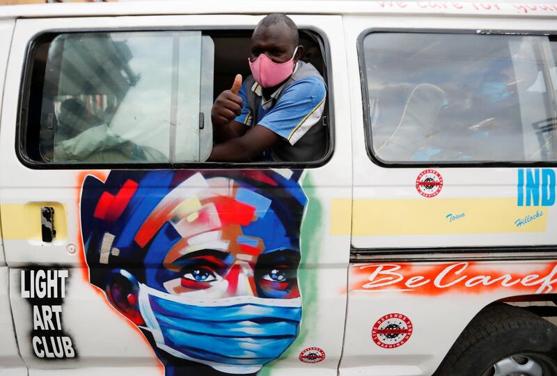 A worker gestures as he peers out of a public service van with a signage on the usage of face masks at the main central bus station, in downtown Nairobi, Kenya June 22. Thomas Mukoya / Reuters