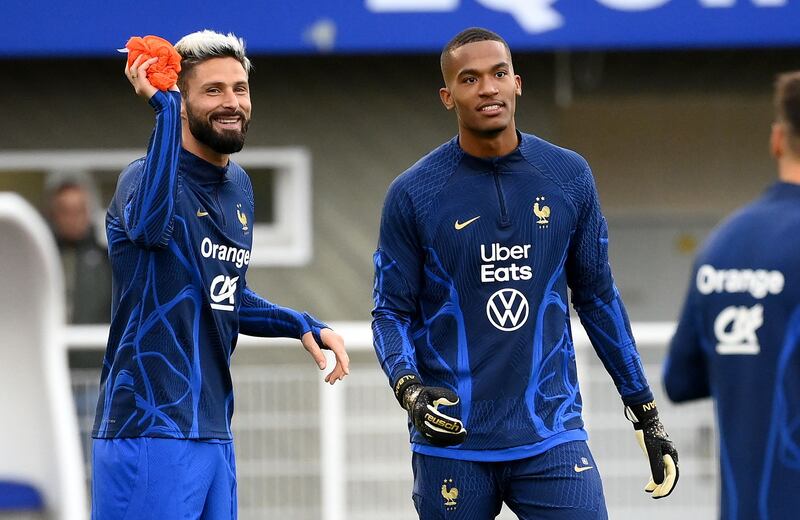 France's forward Olivier Giroud, left, shares a joke with goalkeeper Alban Lafont. AFP