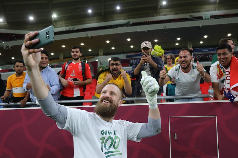 Australia's goalkeeper Andrew Redmayne poses for a selfie with fans after winning the World Cup 2022 playoff against Peru on June 13, 2022, at the Ahmed bin Ali Stadium in Al Rayyan, Qatar. Australia beat Peru 5-4 in a penalty shootout to secure the penultimate free place at the World Cup. AFP