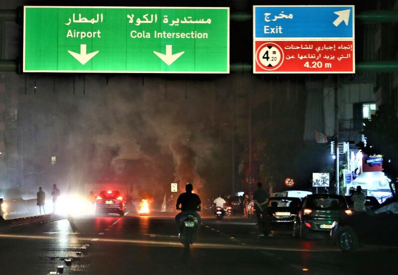 Smoke from burning garbage bins set on fire by anti-government protesters block a main road to the city's airport during a protest over deteriorating living conditions  in Beirut, Lebanon, after the Lebanese government had raised subsidized bread prices.   EPA