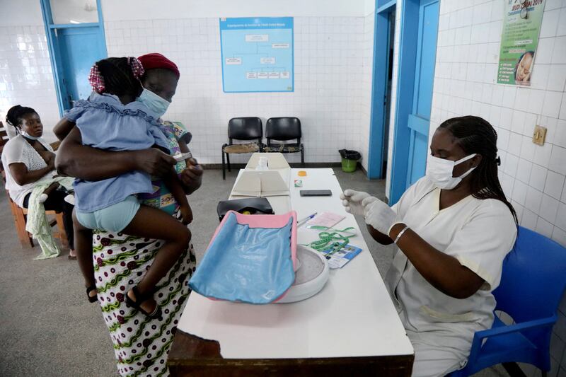 A nurse prepares to tend to a child with malaria at Marcory General Hospital in Abidjan, Ivory Coast, on October 7, 2021.  Reuters 
