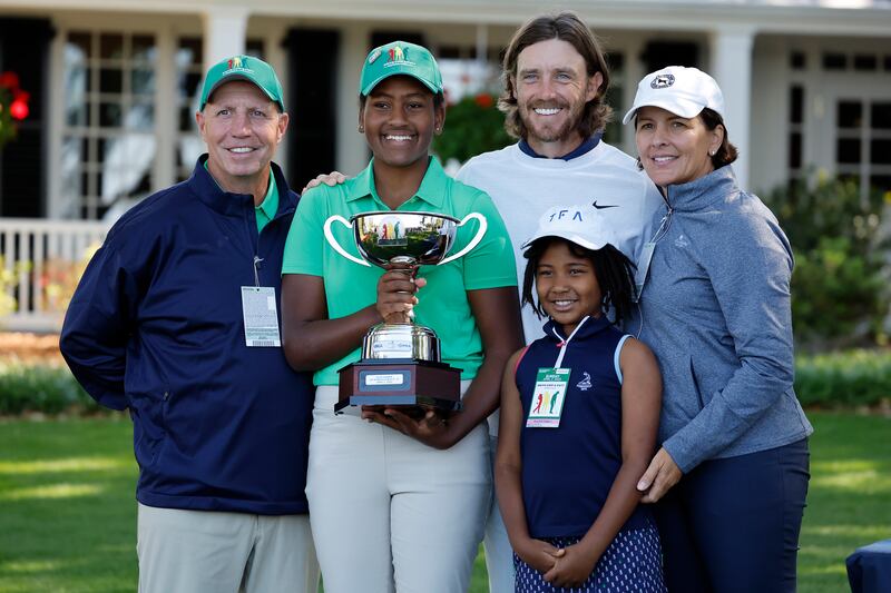 Maya Palanza Gaudin poses with the Drive, Chip and Putt trophy alongside father Stephen Gaudin, left, mother, Cassandra, right, sister Willa, second right, Tommy Fleetwood at Augusta National Golf Club. EPA