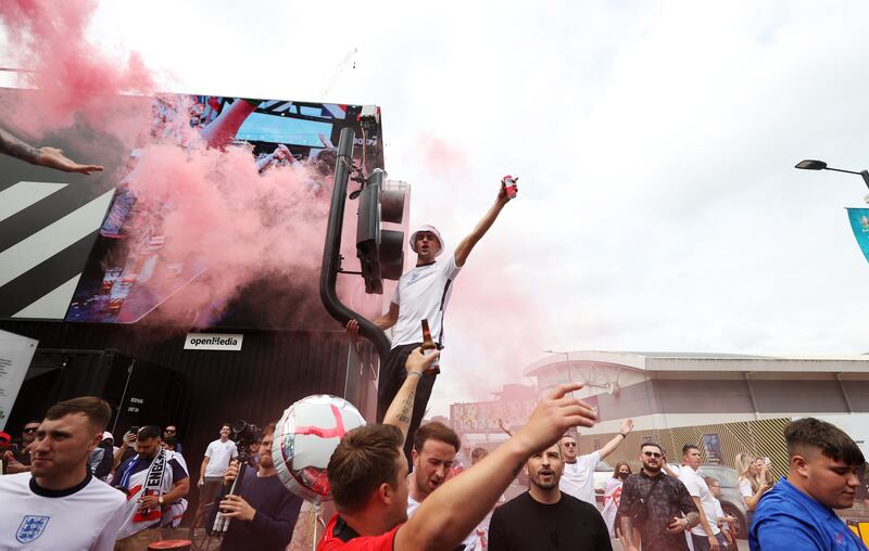 England fans with flares gather outside Wembley stadium ahead of the Euro 2020 final against Italy.