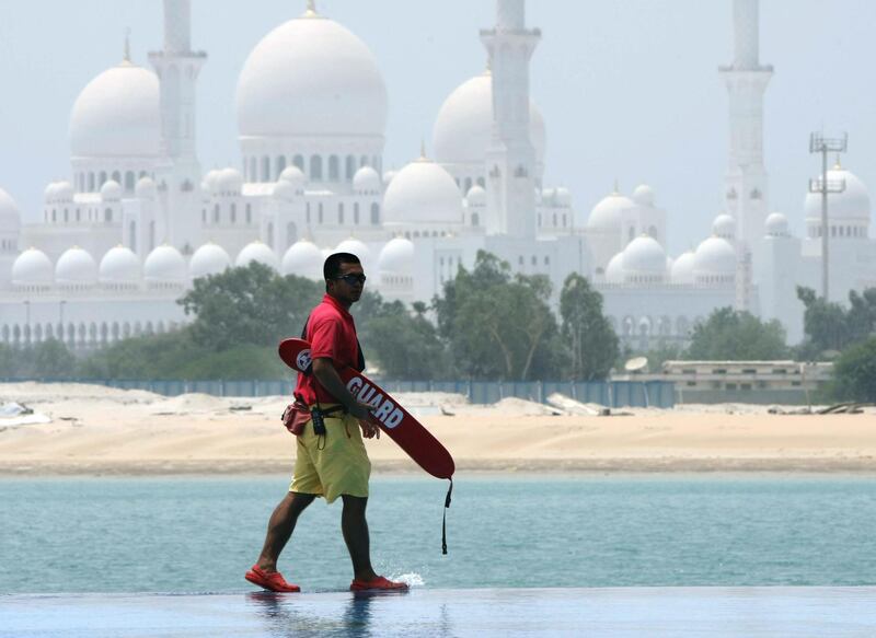 Abu Dhabi. 10th August 2008. Walking on water...Overlooking the Sheikh Zayed mosque a  lifeguard patrols the swimming pool of the Shangri -La hotel, Qaryat al Beri, Abu Dhabi.  Stephen Lock  /  The National.  *** Local Caption ***  SL-lifeguard-003.jpgSL-lifeguard-003_Cropped3.jpg