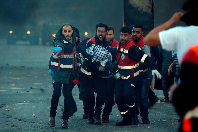 Palestinian medics evacuate a wounded Palestinian protester during clashes between Israeli troops and Palestinian demonstrators in Ramallah. AFP