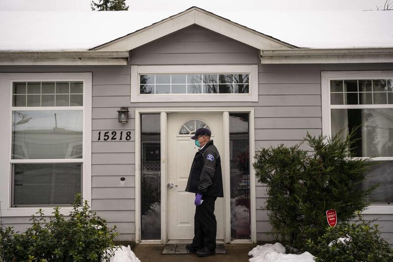 Nathan Downey, part of a mobile vaccination team with the Shoreline Fire Department, drops off vaccination cards at an adult family home after helping to vaccinate residents and staff in Shoreline, Washington. AFP