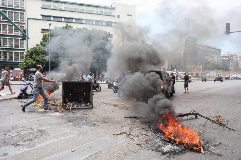 Demonstrators light fires at a road block in the street during an anti-government protest in Beirut, Lebanon. Bloomberg