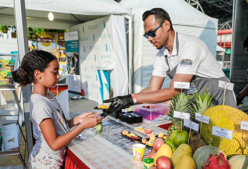 Abu Dhabi, United Arab Emirates, November 9, 2019.  
Taste of Abu Dhabi at the Du Arena.  
--Zaki Osman gives out fresh fruits at the food fair.
Victor Besa/The National
Section:  NA
Reporter: