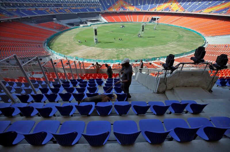 A member of a bomb disposal squad from Gujarat Police uses a sniffer dog to scan the stands at Sardar Patel Gujarat Stadium. Reuters