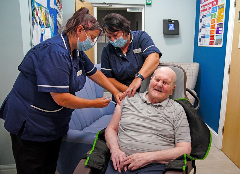 Care home resident Jeff Collins receives a Covid booster vaccination at a nursing home in Bury, northern England. PA