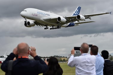 Plane enthusiasts watch an Airbus A380 during a flight demonstration at the Farnborough International Air show in Britain. Airbus will shut down production of the superjumbo due to weaker than expected demand. EPA