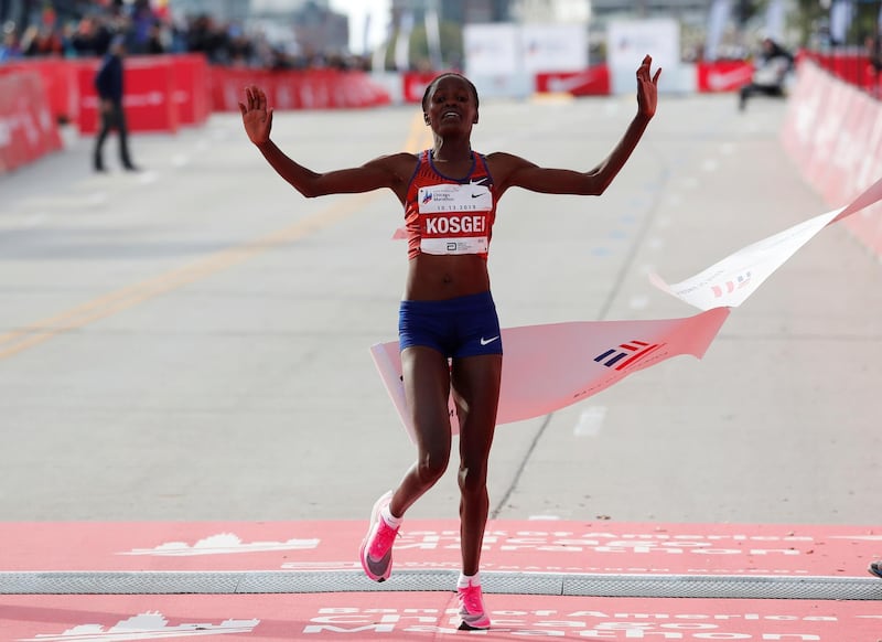 Kenya's Brigid Kosgei celebrates as she crosses the finish line to win the women's marathon, setting a new world record. Reuters