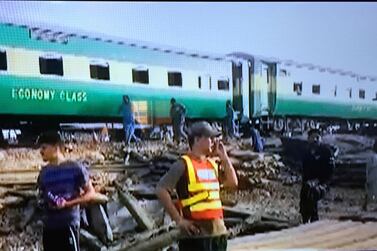 In this image made from video from Geo Tv, shows rescue volunteers working at a train crash site in Rahim Yar Khan, Pakistan. Geo Tv via AP