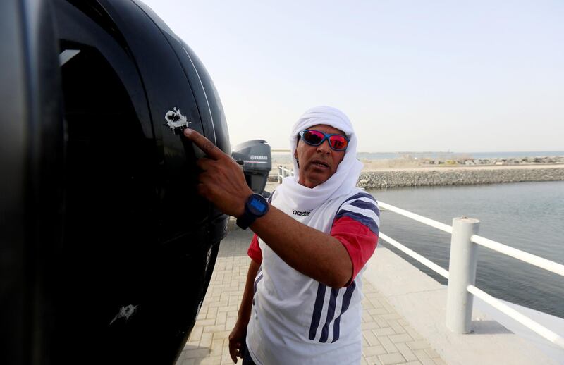 Fujairah, April 26, 2018: Yousef Baroun points out at the bullet shots fired by pirates during the interview at the fisherman port in Fujairah . Satish Kumar for the National / Story by Ruba Haza