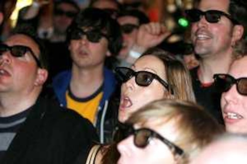Soccer fans wear 3D glasses as they watch the English Premier League soccer match between Arsenal and Manchester United on televisions, broadcast live by Sky Sports, at a pub in London, Sunday, Jan. 31, 2010.   British pay-TV broadcaster Sky transmitted the  Arsenal vs Manchester United soccer match as their first 3D soccer match broadcast to selected venues around the UK on Sunday as a trial for 3D TV. (AP Photo/Akira Suemori) *** Local Caption ***  LSU101_Britain_3D_Soccer_Broadcast.jpg *** Local Caption ***  LSU101_Britain_3D_Soccer_Broadcast.jpg