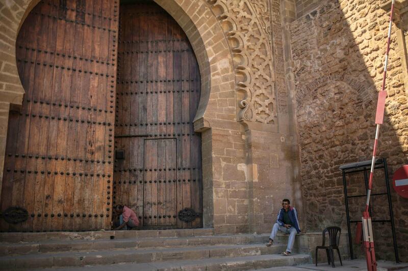 Men work by an ancient gate at the Kasbah of Oudayas, a 12th century fortress famous for its white and blue streets, in Rabat, Morocco.  AP