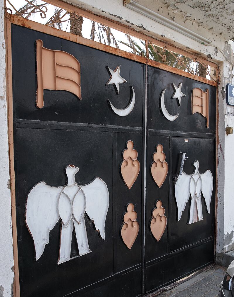 The UAE flag, falcons and stars and crescent moon images are a common choice when decorating doors